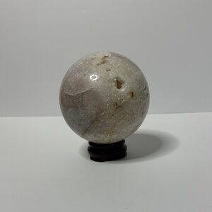 Agate sphere with druzy inclusions. Stand included